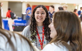 Student smiling at tabling fair
