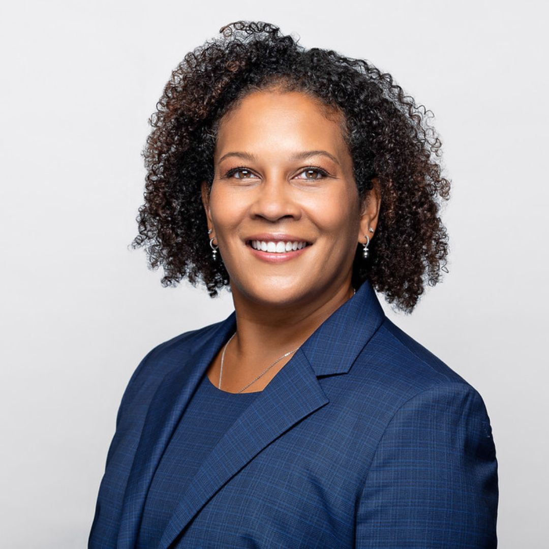 Sonji Jacobs wearing a business suit and smiling for a portrait.
