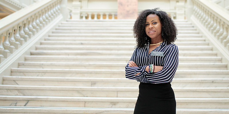 female figure on steps of state capital
