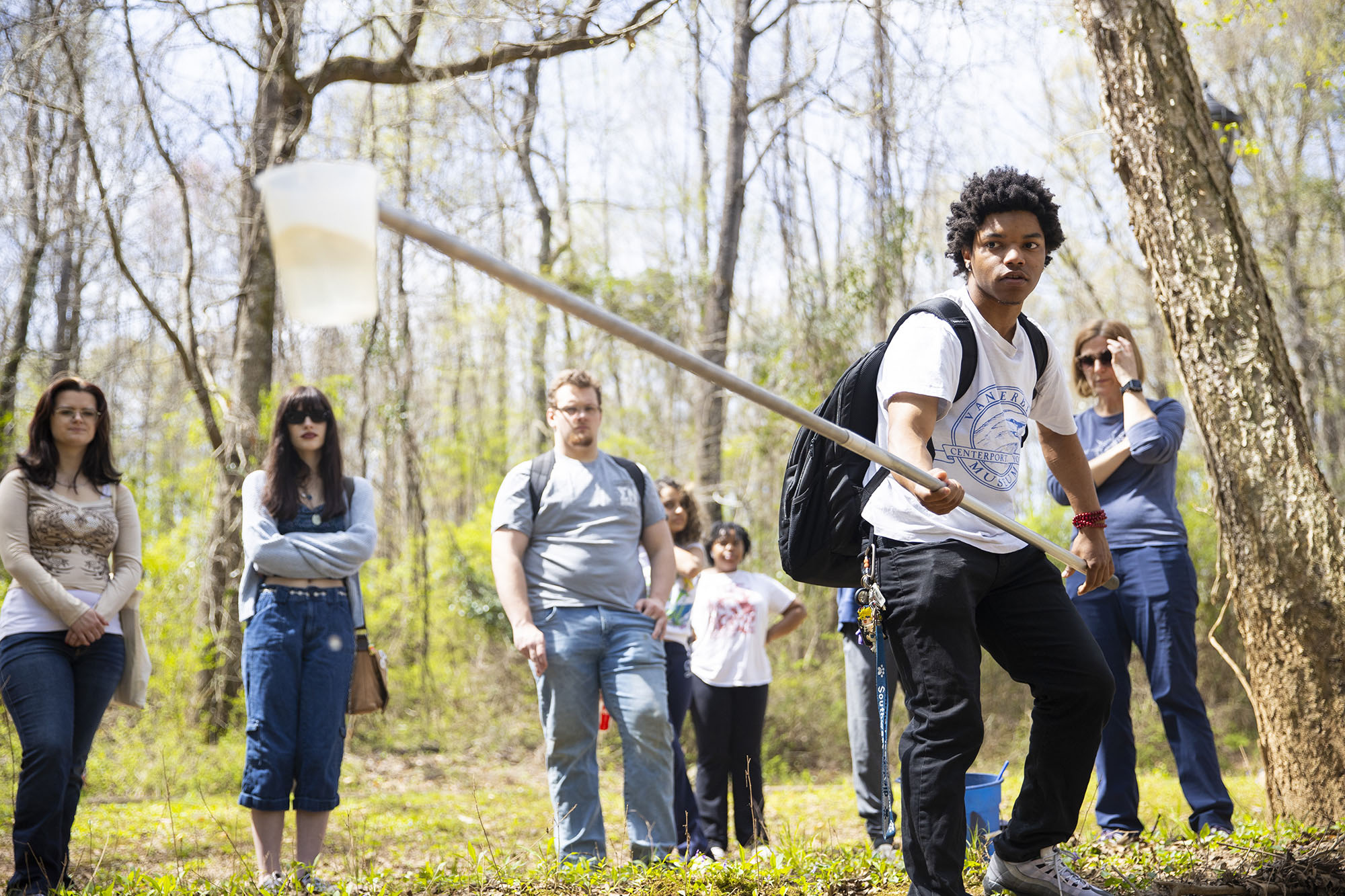 students taking water samples from creek