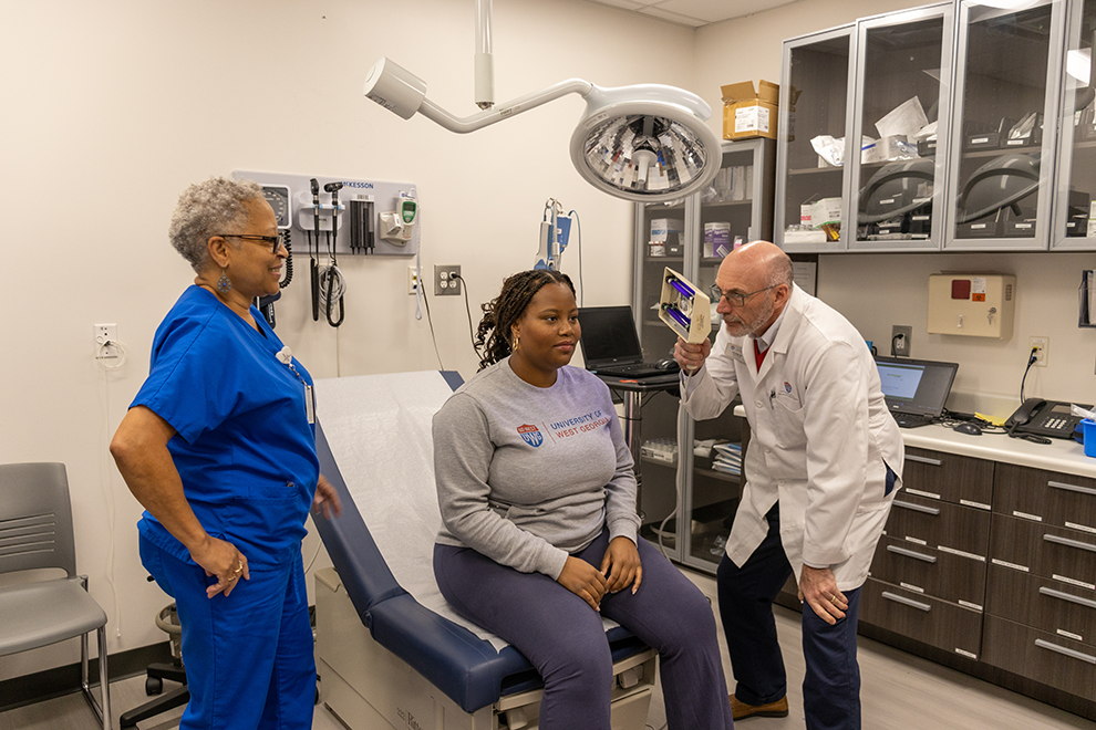 female student receiving medical care from a health services staff members