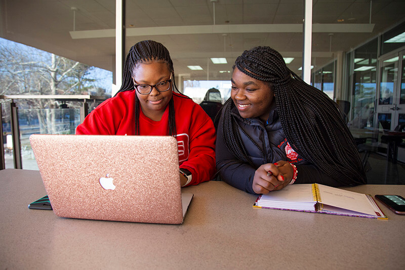 UWG students working at a laptop