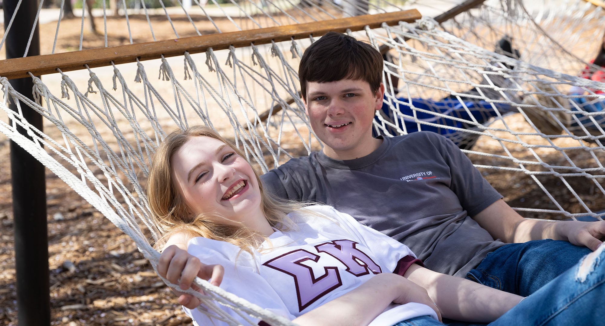 Students on campus in a hammock