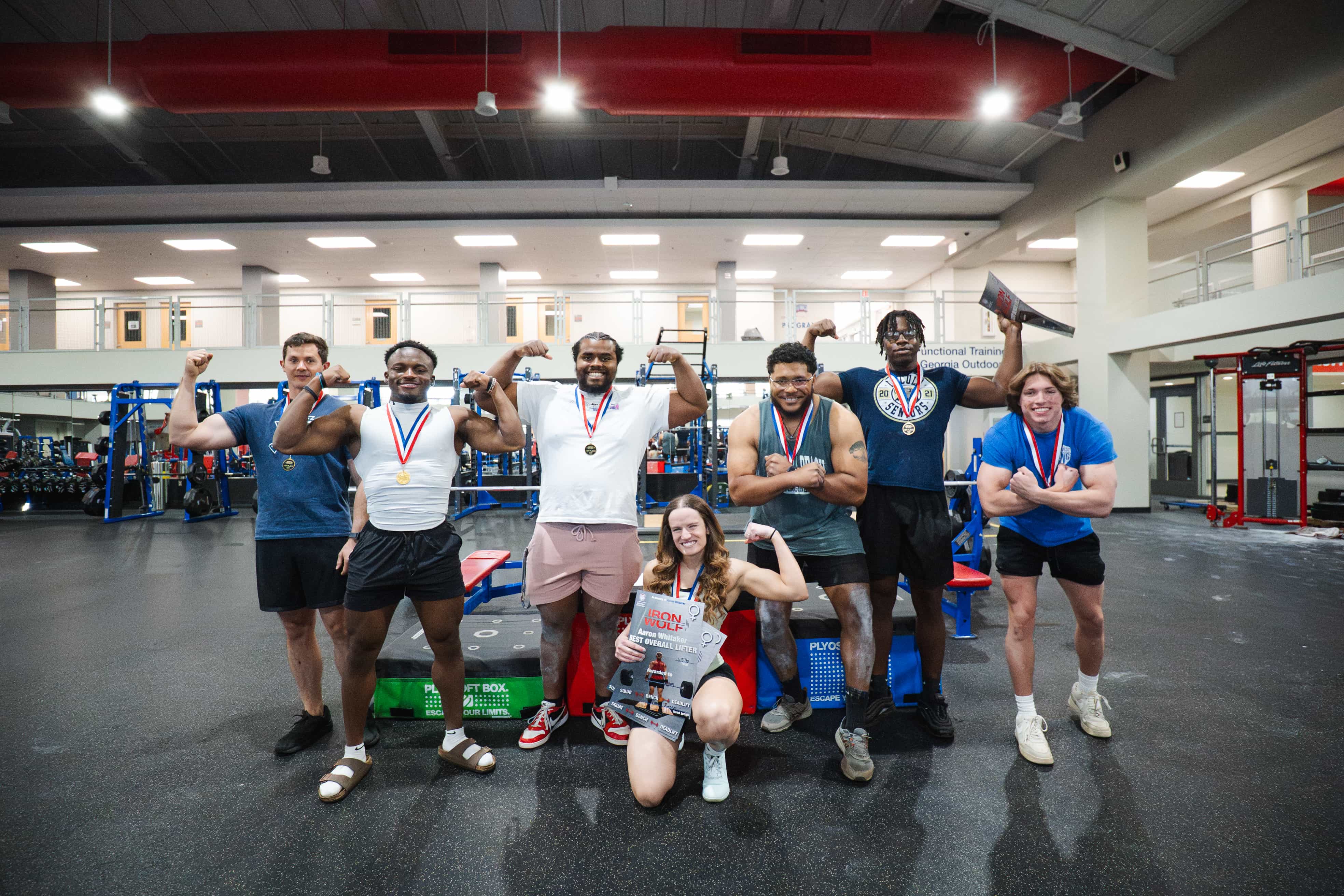 Iron Wolf participants flexing and posing for a group photo.